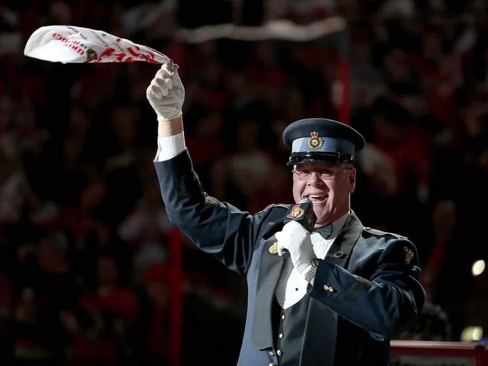 A photo of Lyndon Slewidge singing the anthem at an Ottawa Senators game.