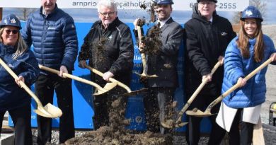 A photo of a bunch of people holding shovels.