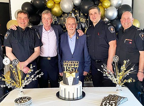 A photo of firefighters with the birthday boy.