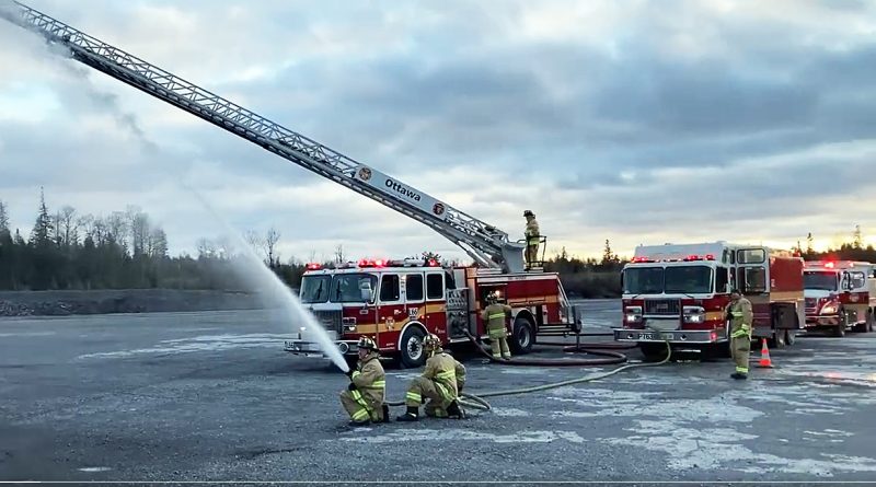 West Carleton firefighters training with a hose.