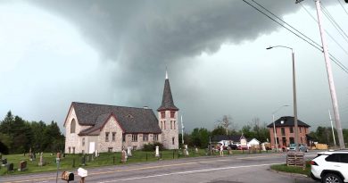A photo of a menacing cloud over a church in Woodlawn.