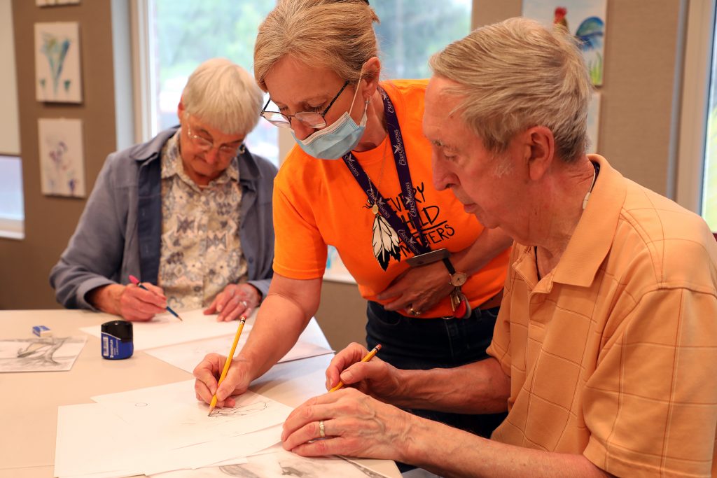 A photo of people working on a drawing.