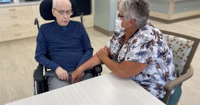 Bruce Flann, Grove resident, and Lynn McLaughlin, RPN, in the Pine Lane dining room. Bruce has moved from another Grove Resident Home Area to Pine Lane.