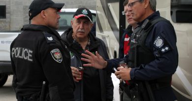 A photo of Coun. Eli El-Chantiry speaking with police.