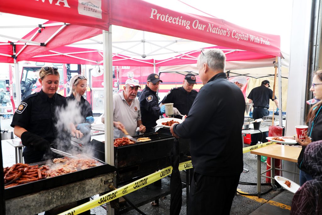 A photo of firefighters cooking breakfast.