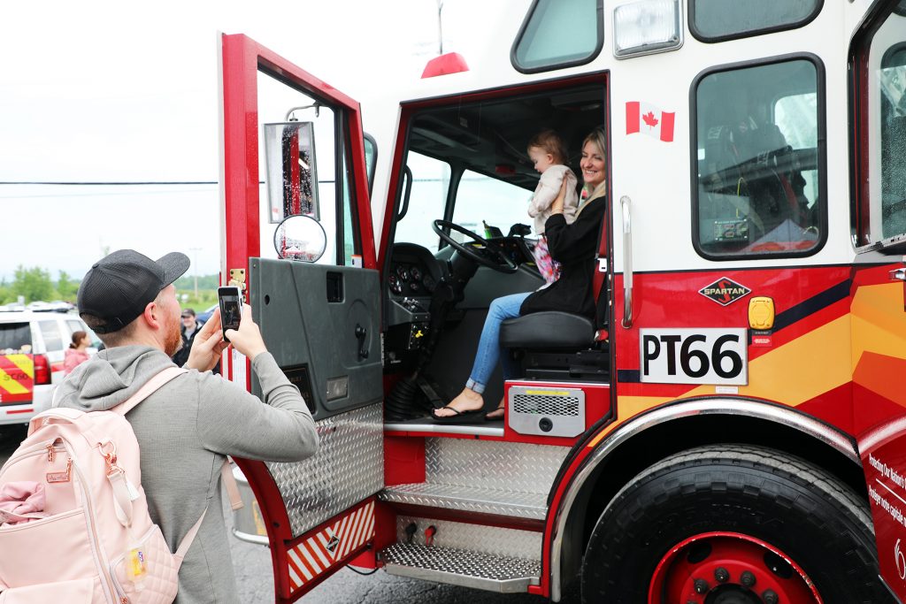 A photo of a family in a fire truck.