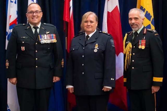 From lef, Canadian Forces Health Service Chief Warrant Officer Martin Bedard, Liz McIntyre and Major General Marc Bilodeau, Surgeon General for the Canadian Forces Health Services.
