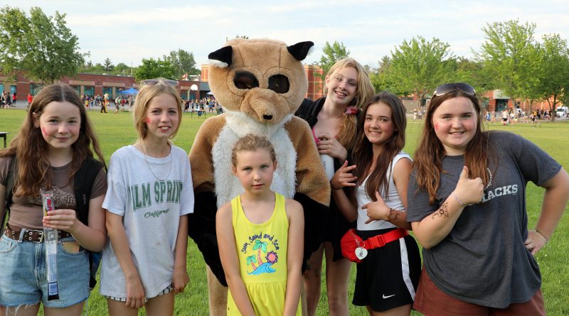 A photo of students and a mascot