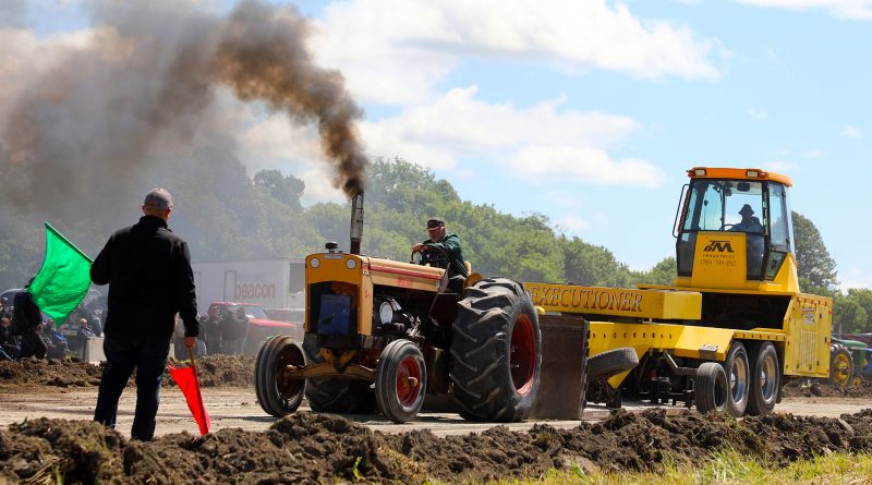 A photo of a tractor pulling.