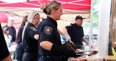A photo of firefighters serving breakfast.
