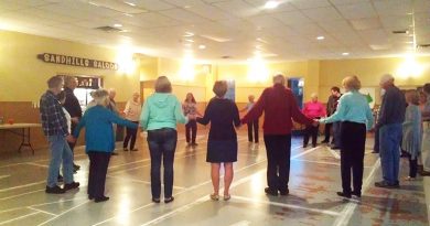 A photo of square dancers performing.