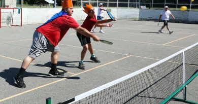 A photo of a father and son playing pickleball.