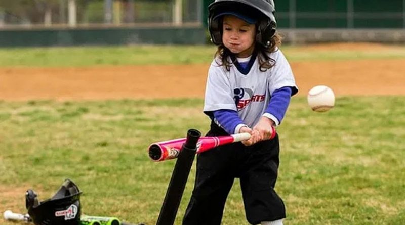 A young girl takes a swing.