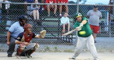 The A’s Ryley Burns takes a rip with Electric catcher Chris Costello behind him during last night’s GOFL Harbour Days Classic. Photo by Jake Davies