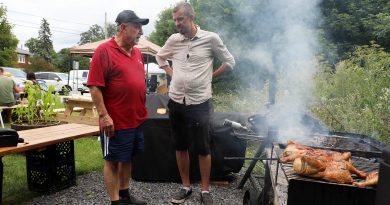 A photo of Eli El-Chantiry and Cory Baird barbecuing.