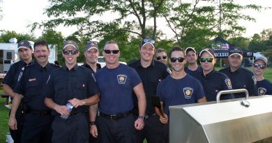A photo of firefighters at the barbecue.