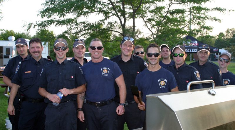 A photo of firefighters at the barbecue.