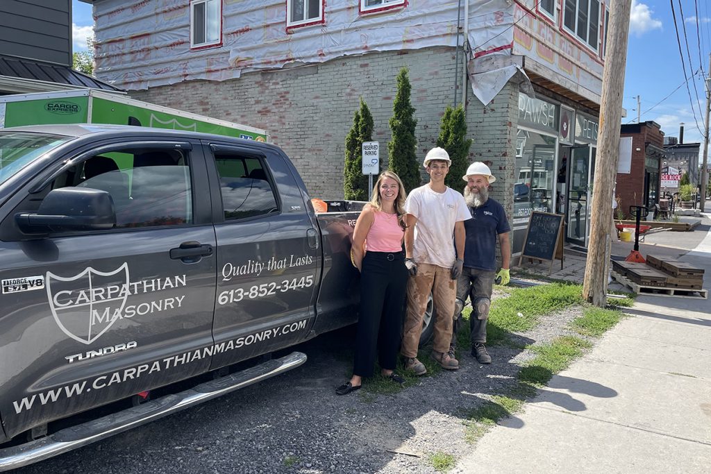 A photo of the MP posing with a student at the job site.