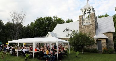 A photo of a tent in front of a church.