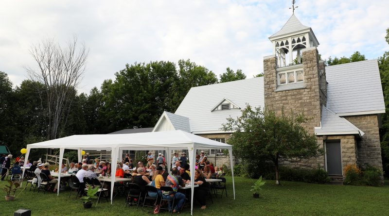 A photo of a tent in front of a church.