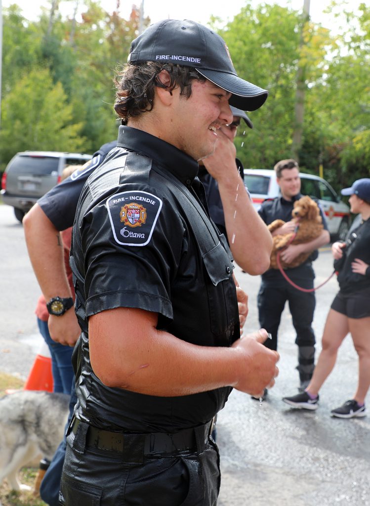 A photo of a wet firefighter.