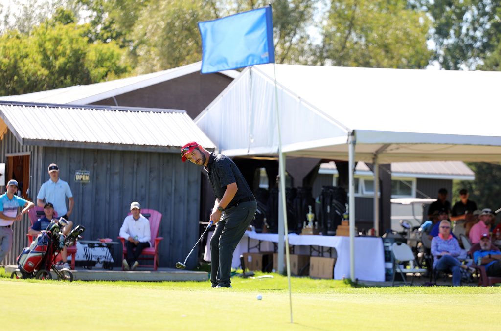 A photo of a man putting on a green.