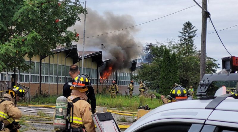 Firefighters battle a fire at a vacant school.