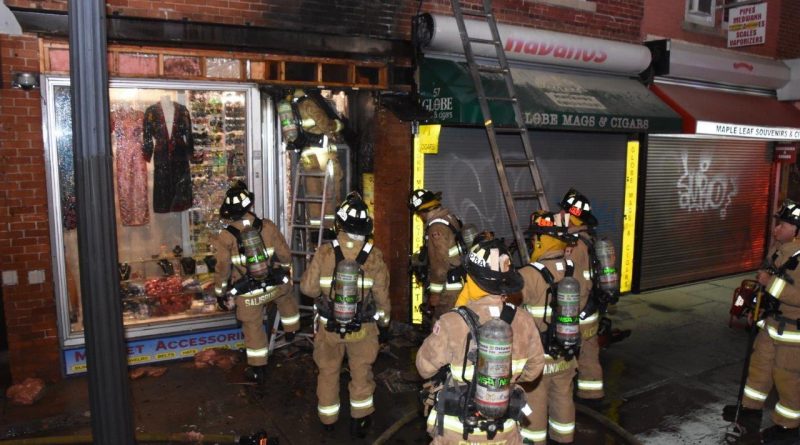 A photo of a storefront on fire.