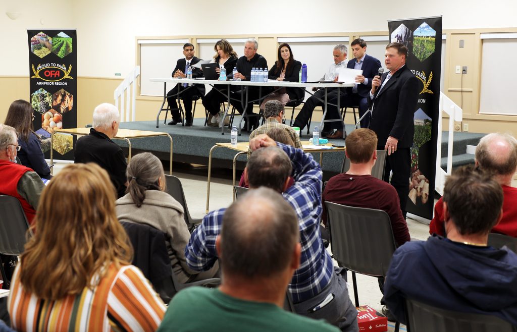 A photo of a room full of people sitting on chairs.