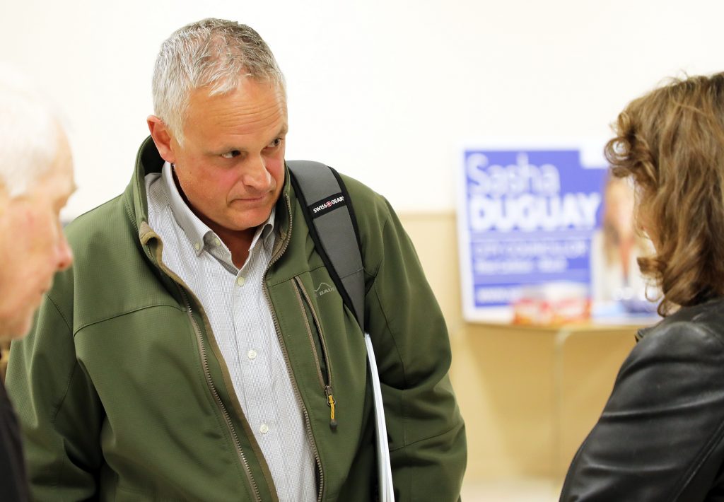 Ian Madill listens to a voter.