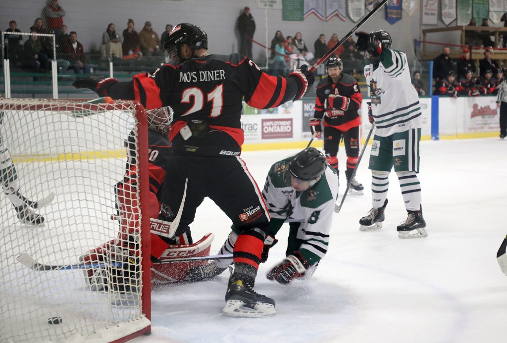 A photo of a puck just barely in the net.