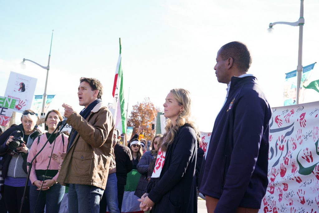 A photo of people speaking at a rally.