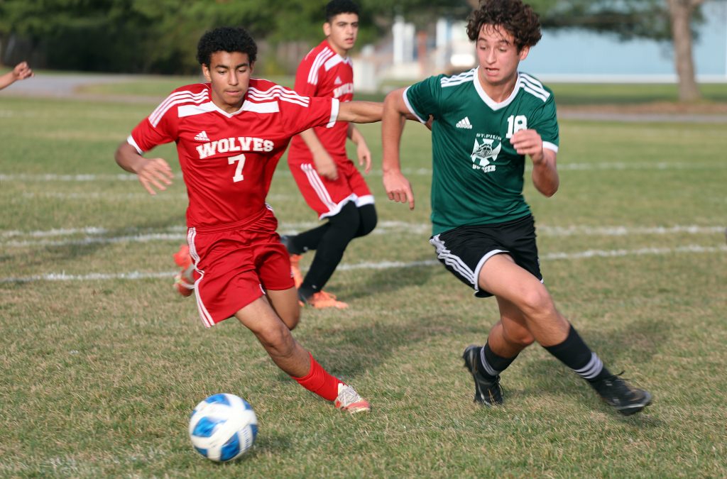 A photo of two soccer players running.