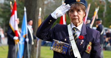 A photo of a woman saluting.