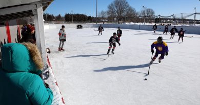A photo of people playing outdoor hockey.