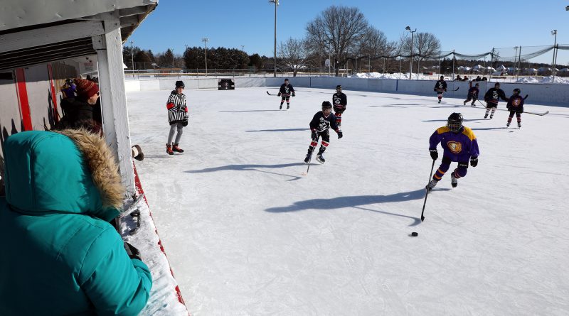 A photo of people playing outdoor hockey.