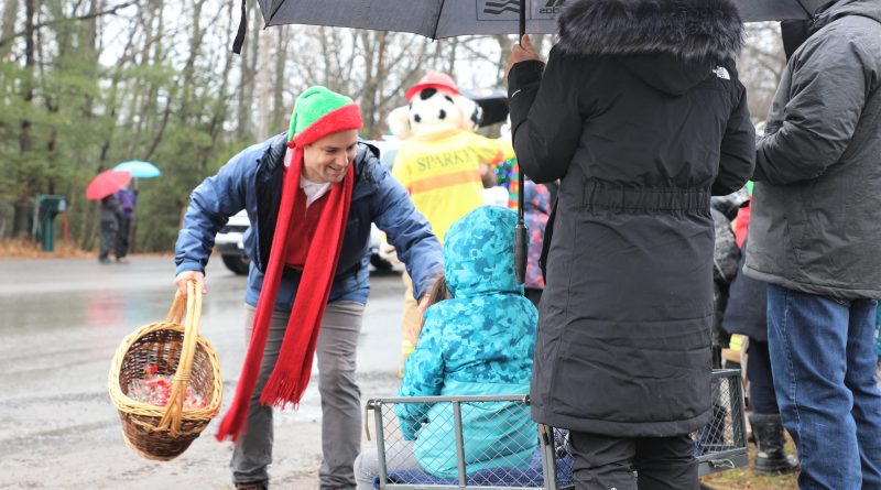 A man gives some kids some candy during a parade.