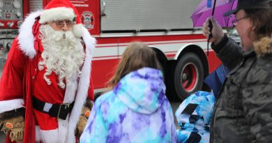 Santa talks to two children.