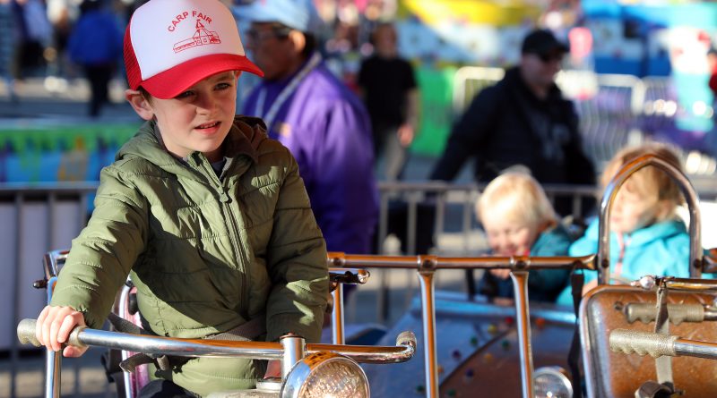 A boy takes a rip on a motorcycle at the Carp Fair.