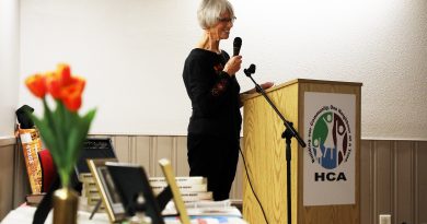 A photo of the author speaking at a podium.