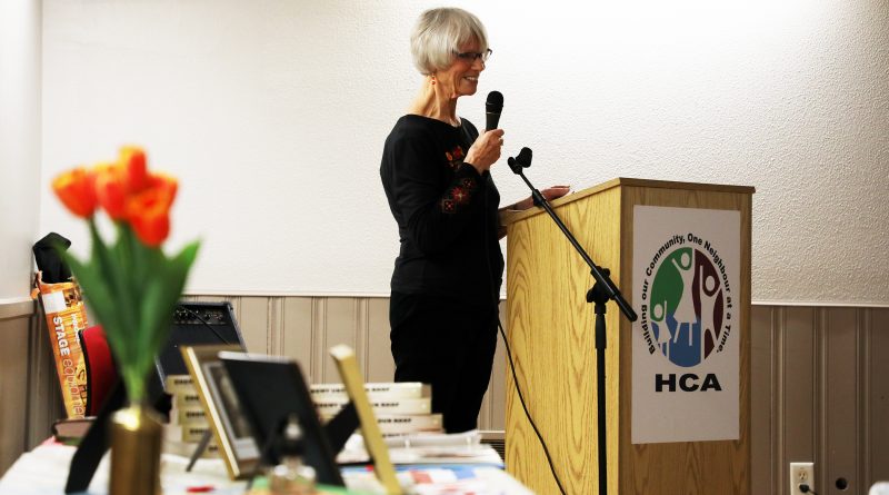 A photo of the author speaking at a podium.