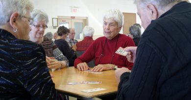 A photo of seniors playing cards.