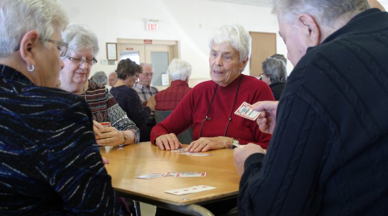 A photo of seniors playing cards.