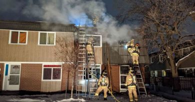 Firefighters battle a row house fire.