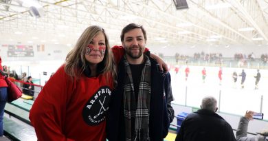 a photo of two politicians at a hockey game.