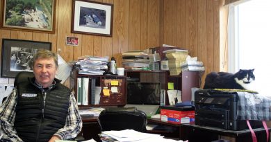 A photo of a man in his office.
