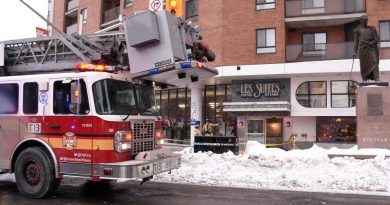 A fire truck is parked in front of a hotel.