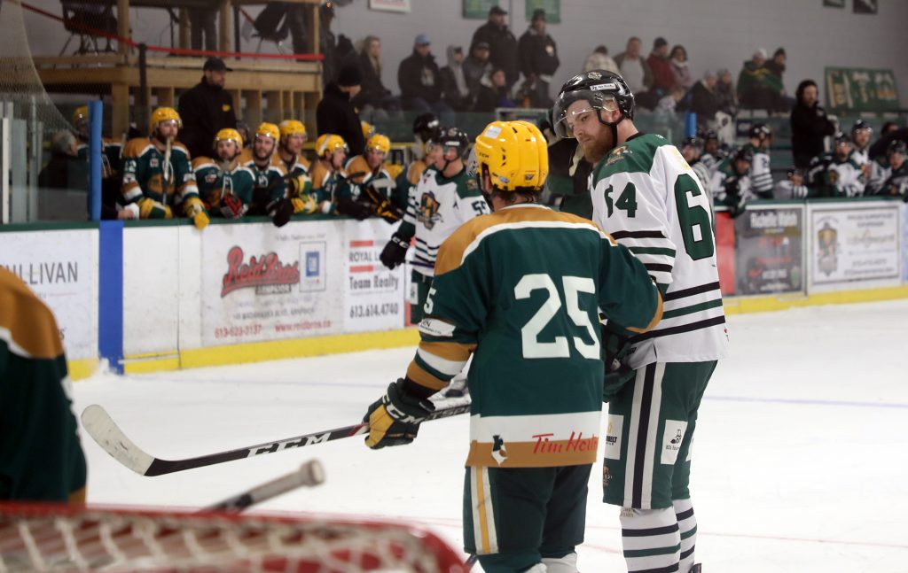 A photo of two hockey players talking.