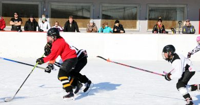 A photo of kids playing outdoor hockey.