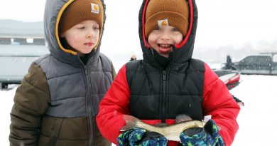 A photo of two boys holding a fish.